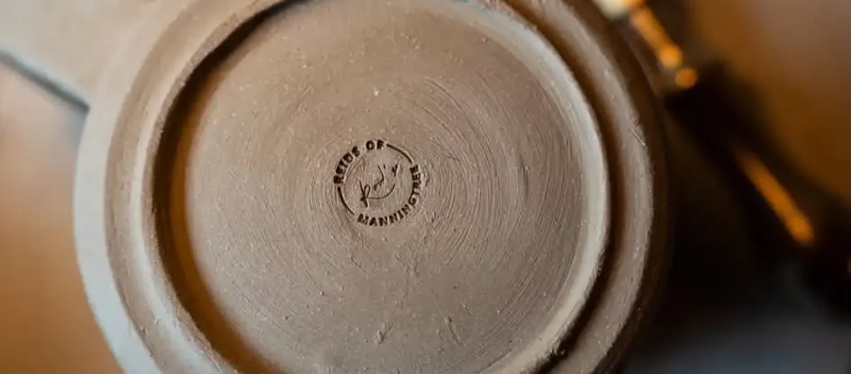 Reid’s maker’s stamp on the base of a handmade pot